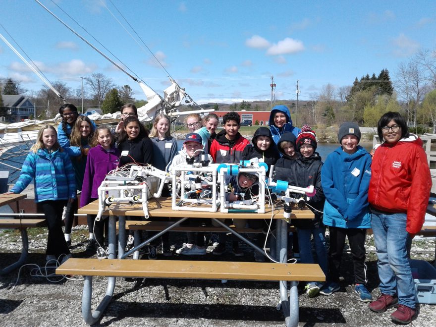 Class  with remotely operated vehicles they made on the picnic table