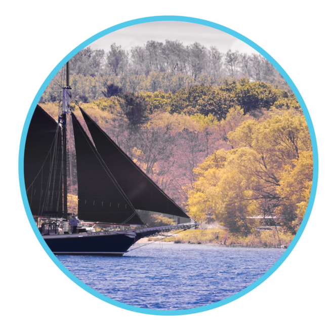 The schooner with fall colored trees in background during this specialty sail