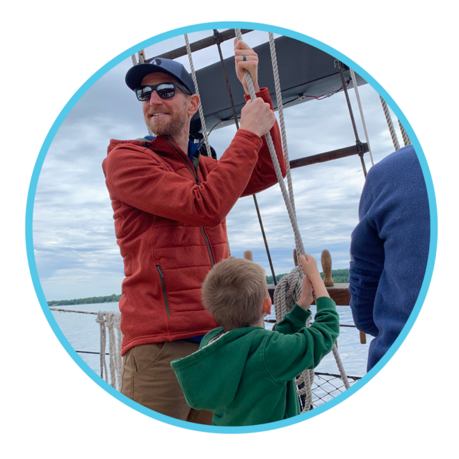 Father and son help raise the sail on this specialty sail