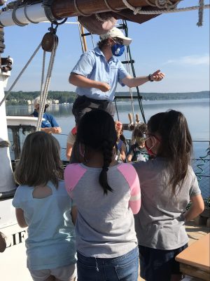 crew member talking to students