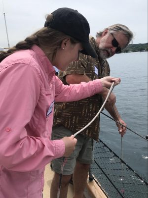 Dad and adult daughter lower the secchi disk