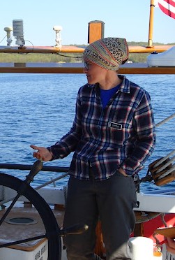 female captain at schooner wheel