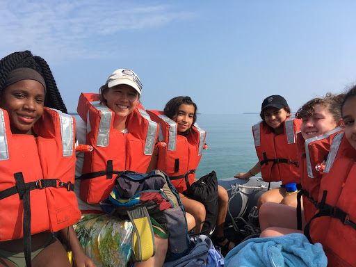 girls with orange lifejackets on dingy