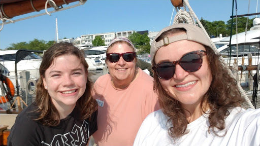 three woman smiling on ship