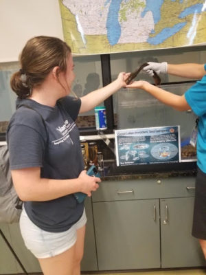 woman intern with sea lamprey on hand