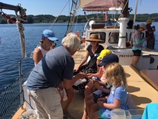 instructor teaching students onboard ship