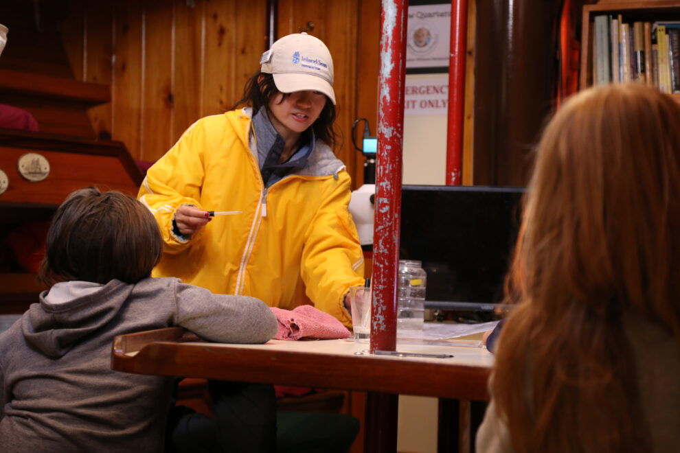 Lia Cook leading the plankton station aboard schooner Inland Seas.